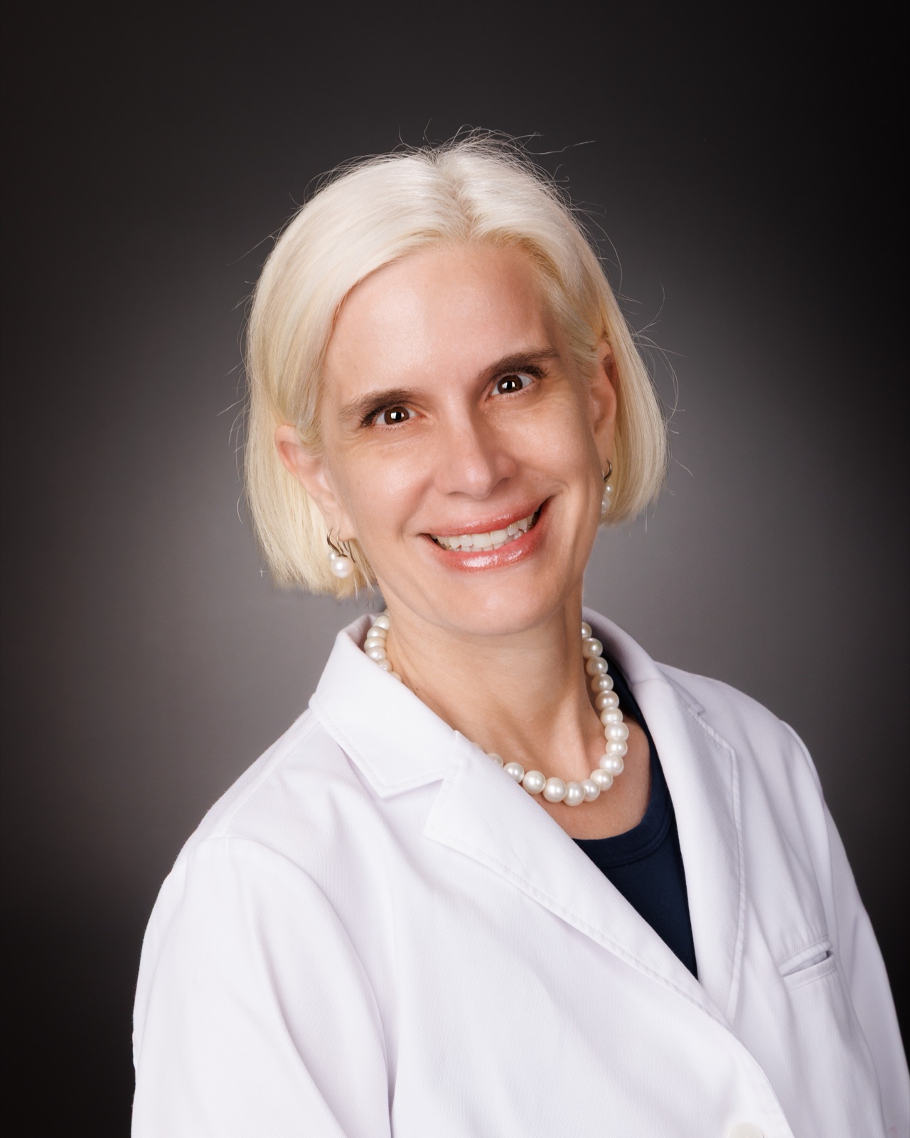 Dr. Helen Mabry in a white coat
